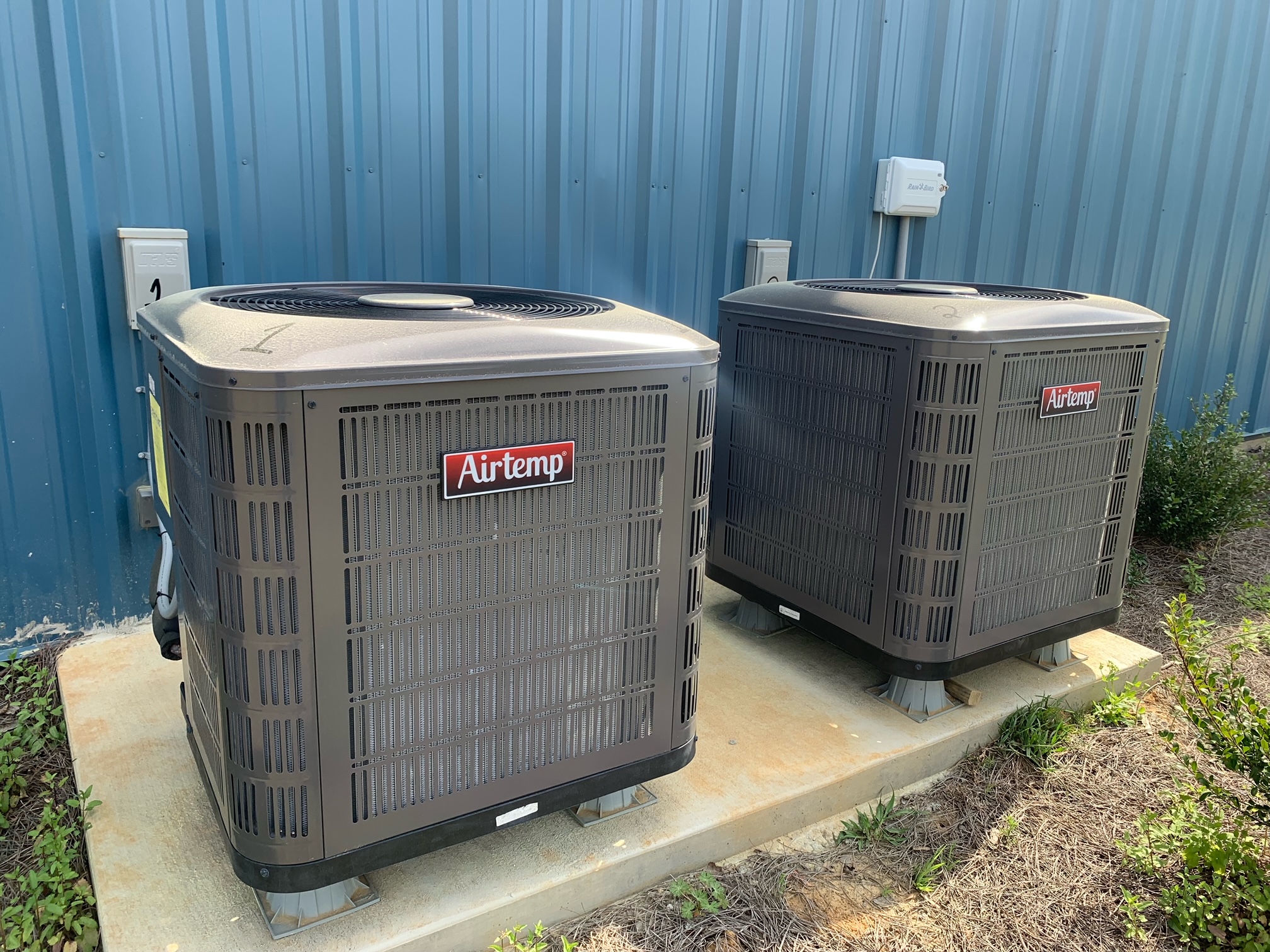 Two Airtemp systems outside on a concrete pad